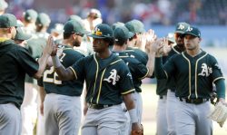 ARLINGTON, TX - OCTOBER 1: Khris Davis #2 of the Oakland Athletics, second from left, celebrates a 5-2 win with his teammates after a baseball game against the Texas Rangers at Globe Life Park October 1, 2017 in Arlington, Texas. (Photo by Brandon Wade/Getty Images)
