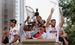 HOUSTON, TX - NOVEMBER 03: Houston Mayor Sylvestor Turner lifts up the Championship Trophy as Carlos Correa #1, Astros owner Jim Crane and George Springer #4 during the Houston Astros Victory Parade on November 3, 2017 in Houston, Texas. The Astros defeated the Los Angeles Dodgers 5-1 in Game 7 to win the 2017 World Series.
