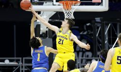 INDIANAPOLIS, INDIANA - MARCH 30: Franz Wagner #21 of the Michigan Wolverines blocks a shot by Jules Bernard #1 of the UCLA Bruins during the first half in the Elite Eight round game of the 2021 NCAA Men's Basketball Tournament at Lucas Oil Stadium on March 30, 2021 in Indianapolis, Indiana. (Photo by Tim Nwachukwu/Getty Images)