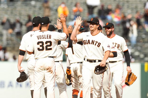 SAN FRANCISCO - APRIL 25: San Francisco Giants players celebrate after their 4-3 win over the Miami Marlins at Oracle Park in San Francisco on Sunday, April, 25, 2021.