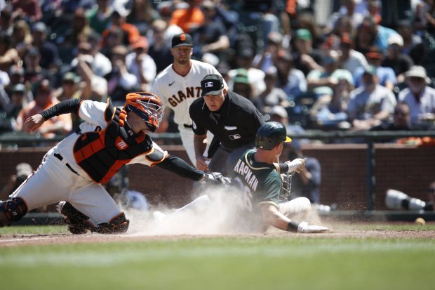 OAKLAND, CA - JUNE 27: Matt Chapman #26 of the Oakland Athletics slides safely into home during the game against the San Francisco Giants at Oracle Park on June 27, 2021 in San Francisco, California. The Athletics defeated the Giants 6-2. (Photo by Michael Zagaris/Oakland Athletics/Getty Images)