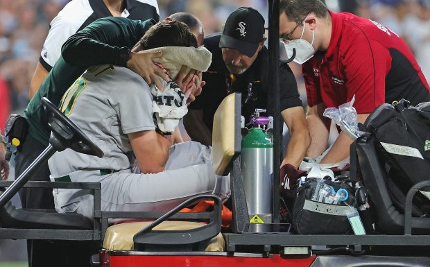 CHICAGO, ILLINOIS - AUGUST 17: Starting pitcher Chris Bassitt #40 of the Oakland Athletics is placed on a cart after being hit in the head by a line drive from Brian Goodwin of the Chicago White Sox in the second inning at Guaranteed Rate Field on August 17, 2021 in Chicago, Illinois. (Photo by Jonathan Daniel/Getty Images)