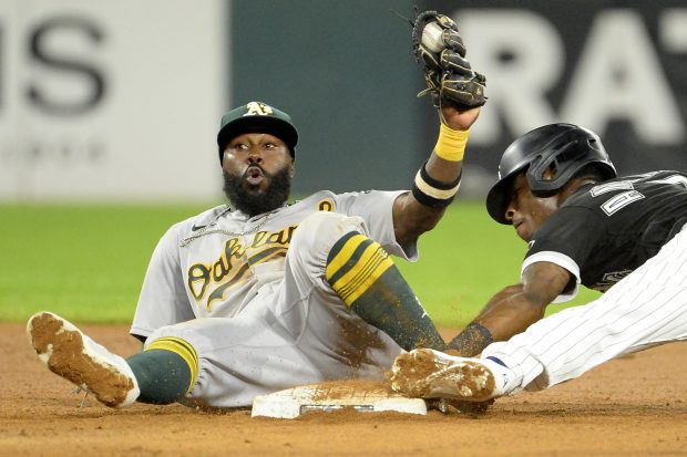 CHICAGO - AUGUST 18: Tim Anderson #7 of the Chicago White Sox steals second base against the Oakland Athletics as Josh Harrison #1 looks on in disbelief on August 18, 2021 at Guaranteed Rate Field in Chicago, Illinois. (Photo by Ron Vesely/Getty Images)