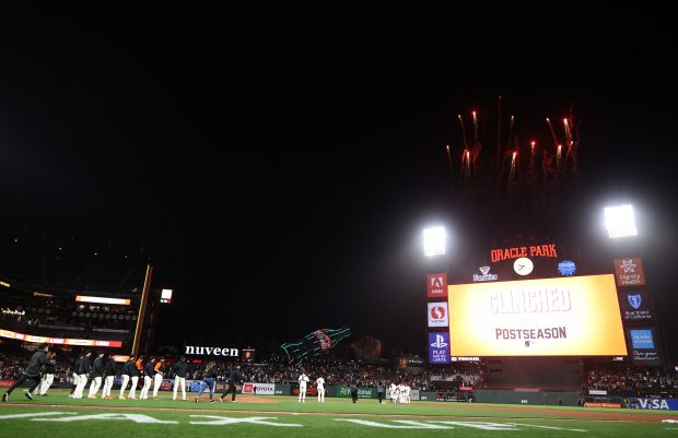 SAN FRANCISCO, CALIFORNIA - SEPTEMBER 13: The San Francisco Giants celebrate as fireworks go off after they clinched a playoff birth by beating the San Diego Padres at Oracle Park on September 13, 2021 in San Francisco, California. (Photo by Ezra Shaw/Getty Images)