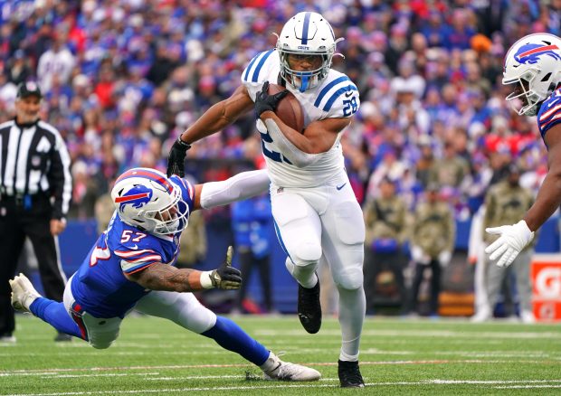 ORCHARD PARK, NEW YORK - NOVEMBER 21: Jonathan Taylor #28 of the Indianapolis Colts avoids a tackle by A.J. Epenesa #57 of the Buffalo Bills during the first quarter at Highmark Stadium on November 21, 2021 in Orchard Park, New York. (Photo by Kevin Hoffman/Getty Images)