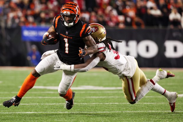 CINCINNATI, OHIO - DECEMBER 12: Ja'Marr Chase #1 of the Cincinnati Bengals is tackled on a carry by Marcell Harris #36 of the San Francisco 49ers during the second half of the game at Paul Brown Stadium on December 12, 2021 in Cincinnati, Ohio. (Photo by Dylan Buell/Getty Images)