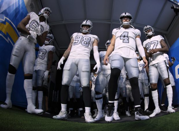 INGLEWOOD, CALIFORNIA - OCTOBER 04: Darius Philon #96, Maxx Crosby #98, Derek Carr #4 and Trayvon Mullen #27 of the Las Vegas Raiders wait in the tunnel before the game against the Los Angeles Chargers at SoFi Stadium on October 04, 2021 in Inglewood, California. (Photo by Harry How/Getty Images)