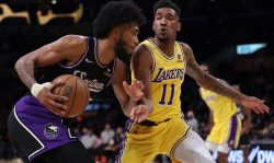 LOS ANGELES, CALIFORNIA - JANUARY 04: Marvin Bagley III #35 of the Sacramento Kings drives to the basket on Malik Monk #11 of the Los Angeles Lakers during the first half at Staples Center on January 04, 2022 in Los Angeles, California. (Photo by Harry How/Getty Images) NOTE TO USER: User expressly acknowledges and agrees that, by downloading and/or using this Photograph, user is consenting to the terms and conditions of the Getty Images License Agreement. Mandatory Copyright Notice: Copyright 2022 NBAE
