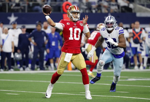 ARLINGTON, TEXAS - JANUARY 16: Jimmy Garoppolo #10 of the San Francisco 49ers throws a pass against the Dallas Cowboys during the third quarter in the NFC Wild Card Playoff game at AT&T Stadium on January 16, 2022 in Arlington, Texas. (Photo by Richard Rodriguez/Getty Images)