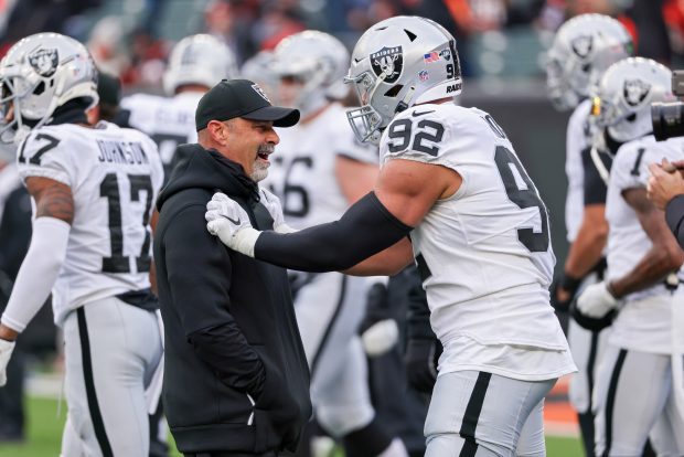 CINCINNATI, OHIO - JANUARY 15: Interim head coach/special teams coordinator Rich Bisaccia of the Las Vegas Raiders meets with Solomon Thomas #92 before the AFC Wild Card playoff game against the Cincinnati Bengals at Paul Brown Stadium on January 15, 2022 in Cincinnati, Ohio. (Photo by Dylan Buell/Getty Images)