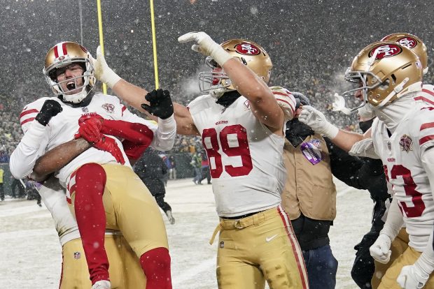 GREEN BAY, WISCONSIN - JANUARY 22: Kicker Robbie Gould #9 of the San Francisco 49ers is congratulated by teammates after kicking the game-winning field goal to win the NFC Divisional Playoff game against the Green Bay Packers at Lambeau Field on January 22, 2022 in Green Bay, Wisconsin. (Photo by Patrick McDermott/Getty Images)