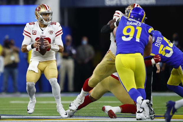 INGLEWOOD, CALIFORNIA - JANUARY 30: Jimmy Garoppolo #10 of the San Francisco 49ers looks to pass the ball in the NFC Championship Game against the Los Angeles Rams at SoFi Stadium on January 30, 2022 in Inglewood, California. (Photo by Ronald Martinez/Getty Images)