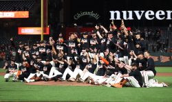 SAN FRANCISCO, CALIFORNIA - SEPTEMBER 13: The San Francisco Giants pose for a team photo on the field after they clinched a playoff birth by beating the San Diego Padres at Oracle Park on September 13, 2021 in San Francisco, California. (Photo by Ezra Shaw/Getty Images)